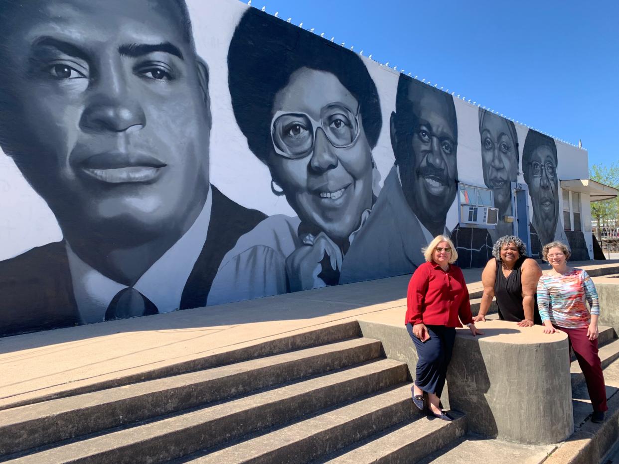 Donna Snowden, longtime Elgin school teacher and local historian, Theresa McShan, the town's first Black mayor, and Amy Miller, the community services director, stand in front of the new "Black Icons Mural" in downtown Elgin. Among the figures depicted is S.H. McShan, a community leader and the mayor's father.