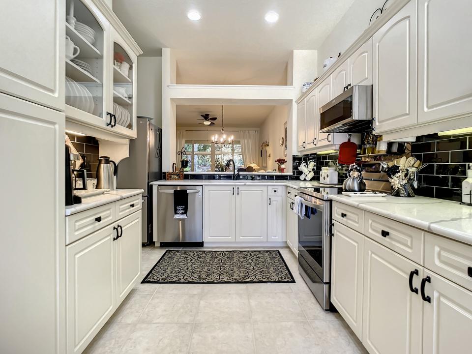 Porcelain-tile floors and $8,000 worth of lighting and electrical upgrades are part of the many renovations that have transformed this stunning townhome.