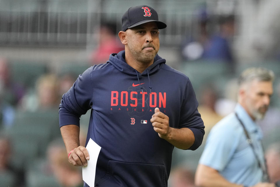 Boston Red Sox manager Alex Cora (13) jogs back to the dugout after exchanging line up cards before a baseball game against the Atlanta Braves Tuesday, May 9, 2023 in Atlanta. (AP Photo/John Bazemore)