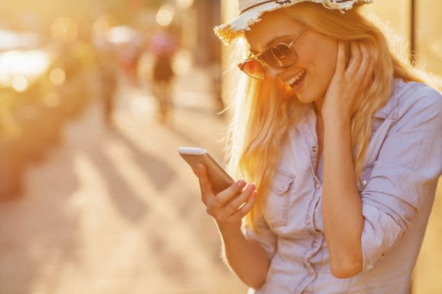 Close up of a young woman looking at mobile phone