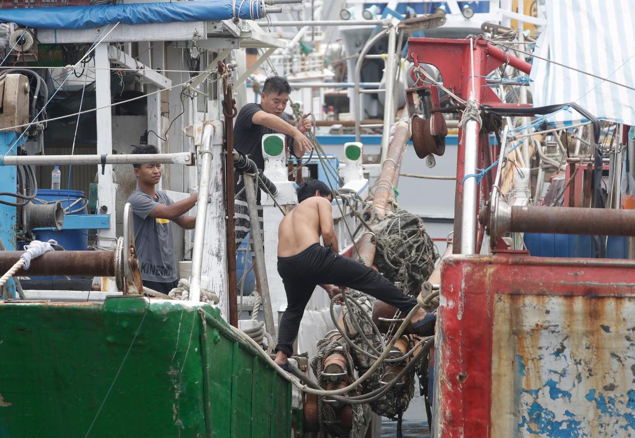 Fishermen stay on a boat while taking shelter as Typhoon Mawar approaches to Taiwan in Yilan County, eastern coast of Taiwan (AP)