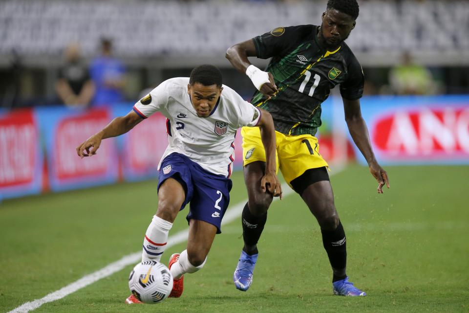 United States defender Reggie Cannon (2) gets past Jamaica forward Daryl Dike (11) with control of the ball in the second half of a CONCACAF Gold Cup quarterfinals soccer match, Sunday, July 25, 2021, in Arlington, Texas. (AP Photo/Brandon Wade)