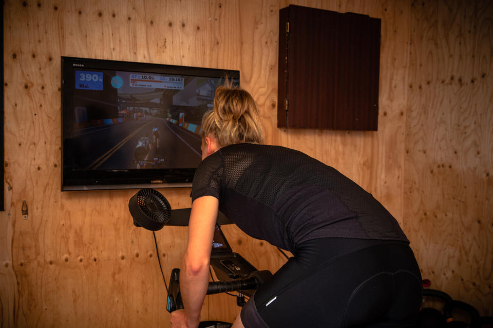 Image shows rider exercising indoors.