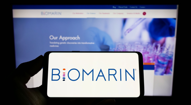 Person holding smartphone with logo of U.S. company BioMarin Pharmaceutical Inc. (BMRN) on screen in front of website. Focus on phone display. Unmodified photo.