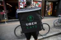 An UberEATS food delivery courier stands in front of his bike in London, Britain September 7, 2016. REUTERS/Neil Hall