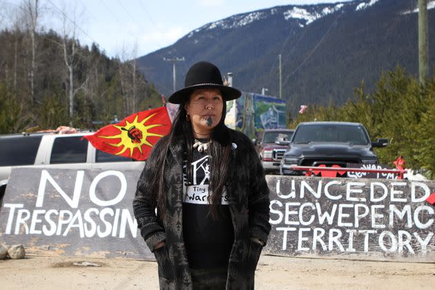 Kanahus Manuel, a member of the Tiny House Warriors, stands in front of an entrance to the Tiny House Warriors village in Blue River, B.C., Canada. (Photo: Aaron Hemens for HuffPost)