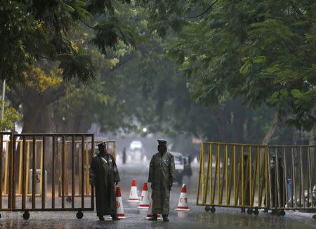 Police officers stand guard at a high security area near a counting centre in Colombo, August 17, 2015. REUTERS/Dinuka Liyanawatte