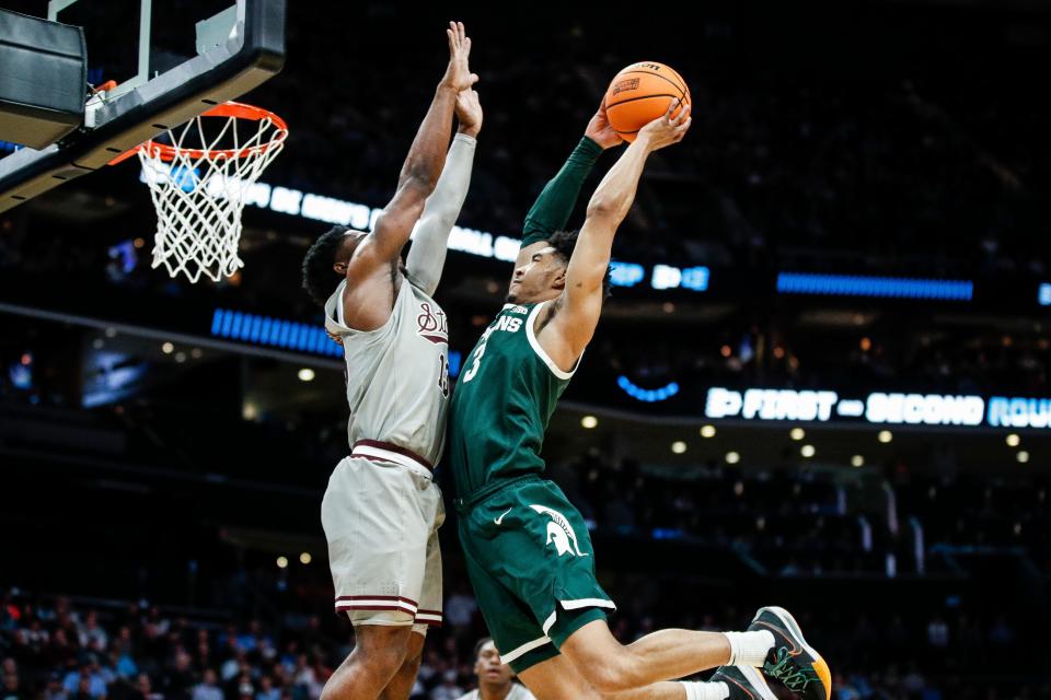 Michigan State guard Jaden Akins (3) goes to the basket against Mississippi State guard Josh Hubbard (13) during the second half of NCAA tournament West Region first round at Spectrum Center in Charlotte, N.C. on Thursday, March 21, 2024.