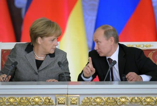 Russian President Vladimir Putin (R) talks to German Chancellor Angela Merkel during their joint press conference in Moscow. The two clashed over the jailing of feminist rock band Pussy Riot as growing bilateral tensions over human rights flared in public