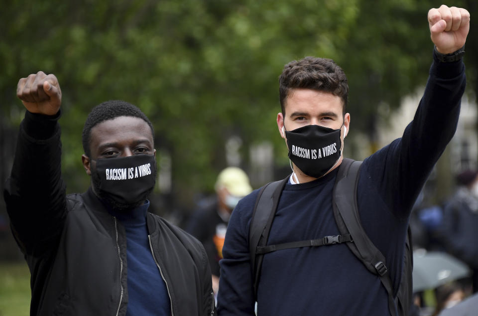 Protestors make a fist during protests in London, Friday, June 12, 2020 in response to the recent killing of George Floyd by police officers in Minneapolis, USA, that has led to protests in many countries and across the US.(AP Photo/Alberto Pezzali)