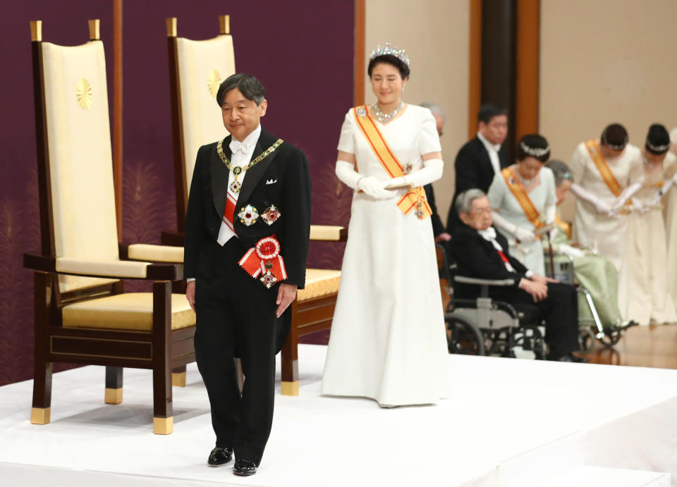 Japan's new Emperor Naruhito, accompanied by new Empress Masako, leaves after making his first address during a ritual after succeeding his father Akihito at Imperial Palace in Tokyo, Wednesday, May 1, 2019. (Japan Pool via AP)