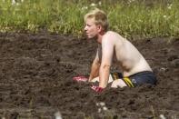 The goalkeeper of HC Elakelaiset (HC Pensioners) takes a rest during a game at the Swamp Soccer World Championships tournament in Hyrynsalmi, Finland July 13, 2018. Picture taken July 13, 2018. Lehtikuva/Kimmo Rauatmaa/via REUTERS