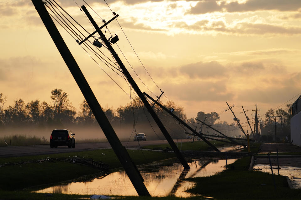 FILE - Downed power lines slump over a road in the aftermath of Hurricane Ida, Sept. 3, 2021, in Reserve, La. Lawmakers on the U.S. Senate Committee on the Budget turned to Louisiana on Wednesday, July 26, 2023, for its hard-earned expertise in the fiscal impacts of climate change. (AP Photo/Matt Slocum, File)