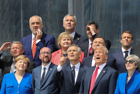 (First row L-R) German Chancellor Angela Merkel, Belgium's Prime Minister Charles Michel, NATO Secretary General Jens Stoltenberg, US President Donald Trump, Britain's Prime Minister Theresa May (second row L-R) Denmark's Prime Minister Lars Lokke Rasmussen, Norway's Prime Minister Erna Solberg, Poland's President Andrzej Duda, French President Emmanuel Macron (third row) Albania's Prime Minister Edi Rama, Czech Republic President Milos Zeman and Spain's Prime Minister Pedro Sanchez pose for a family picture ahead of the opening ceremony of the NATO (North Atlantic Treaty Organization) summit, at the NATO headquarters in Brussels, Belgium July 11, 2018. Ludovic Marin/Pool via REUTERS