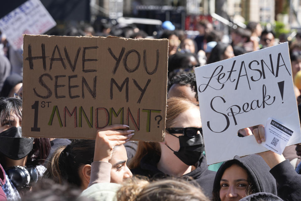 Students carrying signs protest a canceled commencement speech by its 2024 valedictorian who has publicly supported Palestinians on the campus of University of Southern California on Thursday, April 18, 2024. USC was citing security concerns, in a rare decision that was praised by several pro-Israel groups and lambasted by free speech advocates and the country's largest Muslim civil rights organization. (AP Photo/Damian Dovarganes)