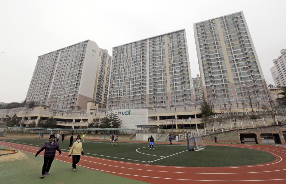 FILE - In this Jan. 28, 2016, file photo, residents exercise at a school near an apartment complex, the former location of the Brothers Home, in Busan, South Korea. A notorious South Korean facility that kidnapped, abused and enslaved children and the disabled for a generation was also shipping children overseas for adoption, part of a massive profit-seeking enterprise that thrived by exploiting those trapped within its walls, The Associated Press has found.(AP Photo/Ahn Young-joon, File)