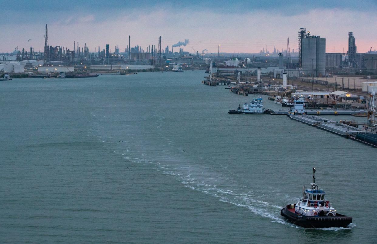 A tug boat travels down the ship channel in the Port of Corpus Christi on April 24, 2022, in Texas. Refineries line the channel in an area dubbed Refinery Row.