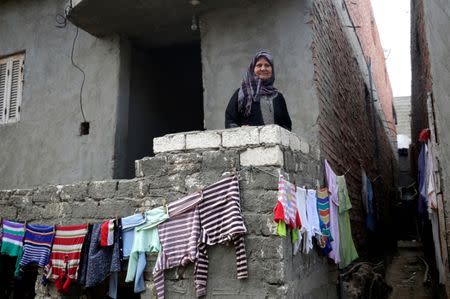 A woman looks out from a balcony at her family house in Egypt's Nile Delta village of El Shakhluba, in the province of Kafr el-Sheikh, Egypt May 5, 2019. Picture taken May 5, 2019. REUTERS/Hayam Adel