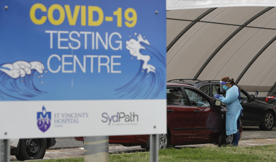 People wait at a drive through COVID-19 testing station at a beach in Sydney, Australia, Saturday, Dec. 19, 2020. Sydney's northern beaches will enter a lockdown similar to the one imposed during the start of the COVID-19 pandemic in March as a cluster of cases in the area increased to more than 40. (AP Photo/Mark Baker)