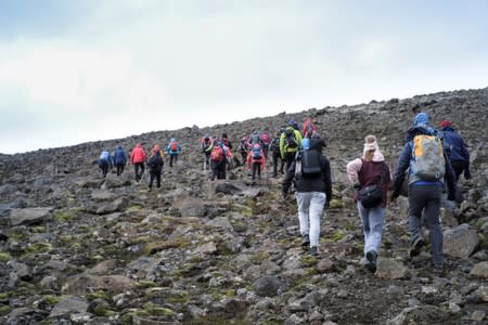 People walk towards Okjokull glacier in Iceland