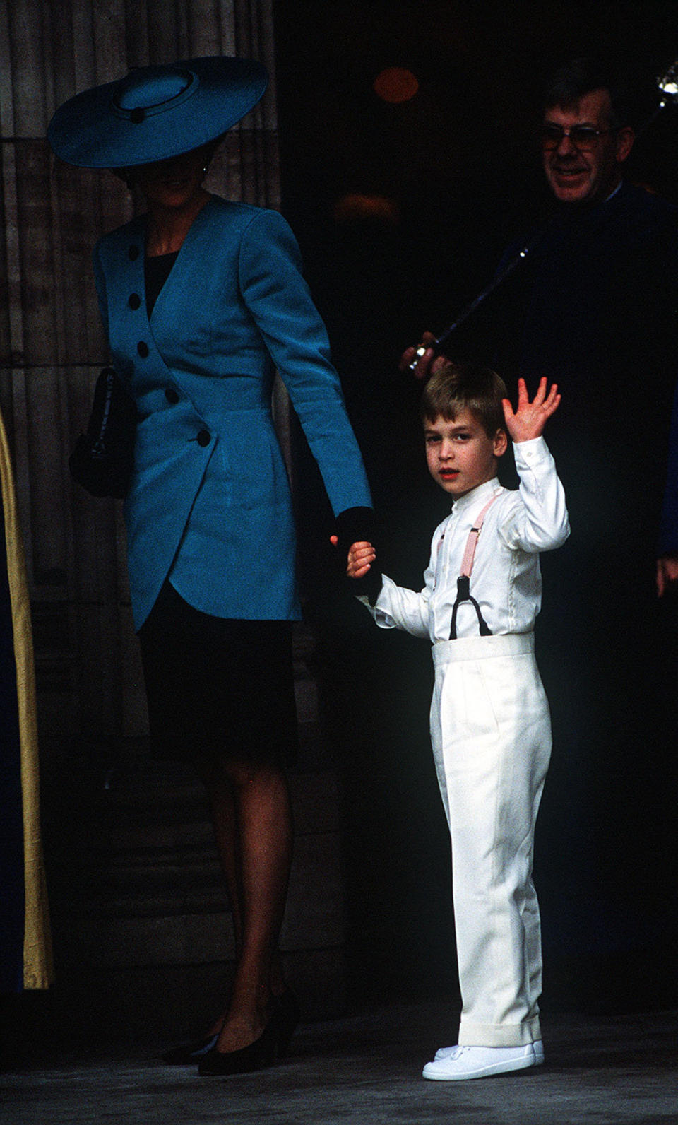 Princess Diana&nbsp;leads&nbsp;Prince William along as he waves to onlookers.