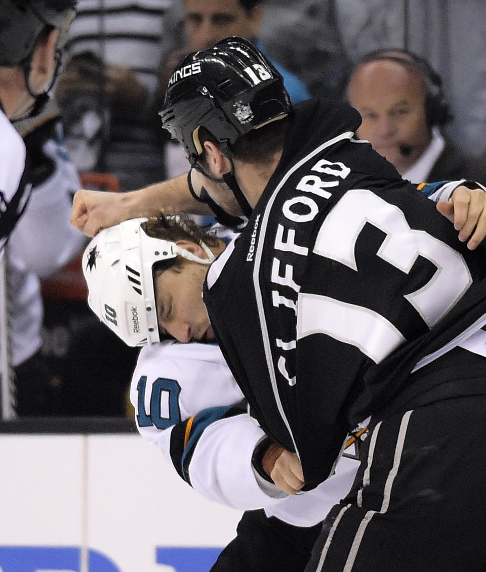 San Jose Sharks center Andrew Desjardins, left, fights with Los Angeles Kings left wing Kyle Clifford during the first period in Game 6 of an NHL hockey first-round playoff series, Monday, April 28, 2014, in Los Angeles. (AP Photo)