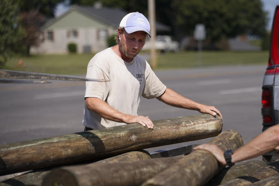 Mark Cook loads lumber onto a trailer, Tuesday, Oct. 3, 2023, in Bowling Green, Ky. Voters across Kentucky are making their choices ahead of the Nov. 7 gubernatorial showdown between Democratic Gov. Andy Beshear and his GOP challenger, Daniel Cameron. (AP Photo/George Walker IV)