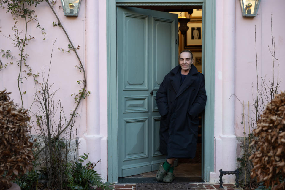 Galliano in the doorway of his home
