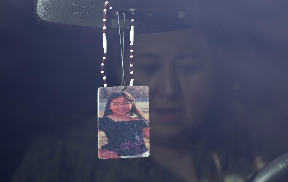 Veronica Mata sits in her vehicle behind a photo of her daughter, Tess, in Uvalde, Texas, Wednesday, May 3, 2023. For Mata, teaching kindergarten in Uvalde after her daughter was among the 19 students who were fatally shot at Robb Elementary School became a year of grieving for her own child while trying to keep 20 others safe. (AP Photo/Eric Gay)