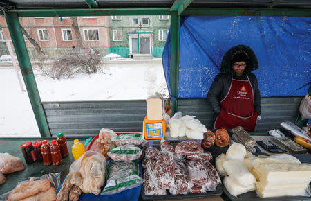 A street food vendor Nina waits for customers at a small market in the town of Aksu, north-eastern Kazakhstan, February 21, 2018. REUTERS/Shamil Zhumatov