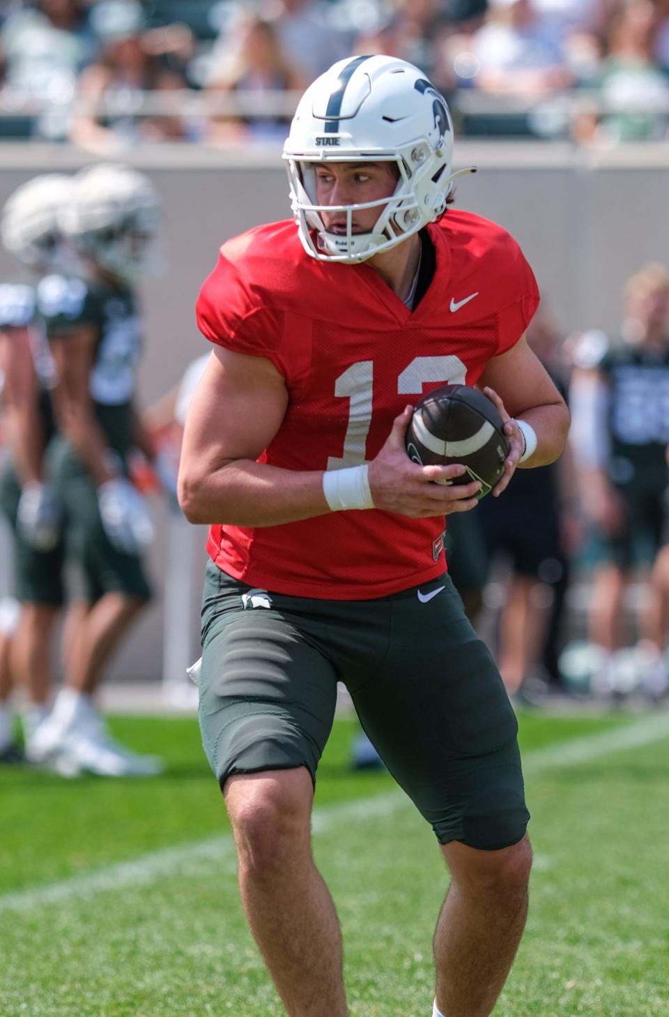 Quarterback Katin Houser (12) runs through some drills at the Michigan State Spring Game in Spartan Stadium Saturday, April 15, 2023.