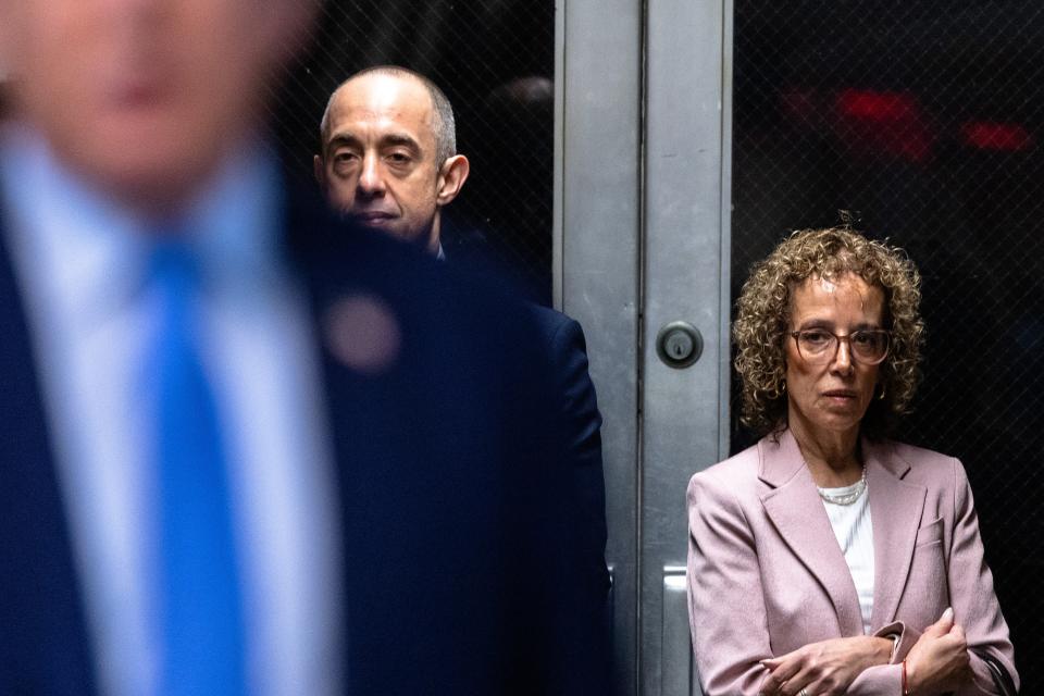 Attorneys Emil Bove (C) and Susan Necheles (R) stand silently as Trump speaks to media (EPA)