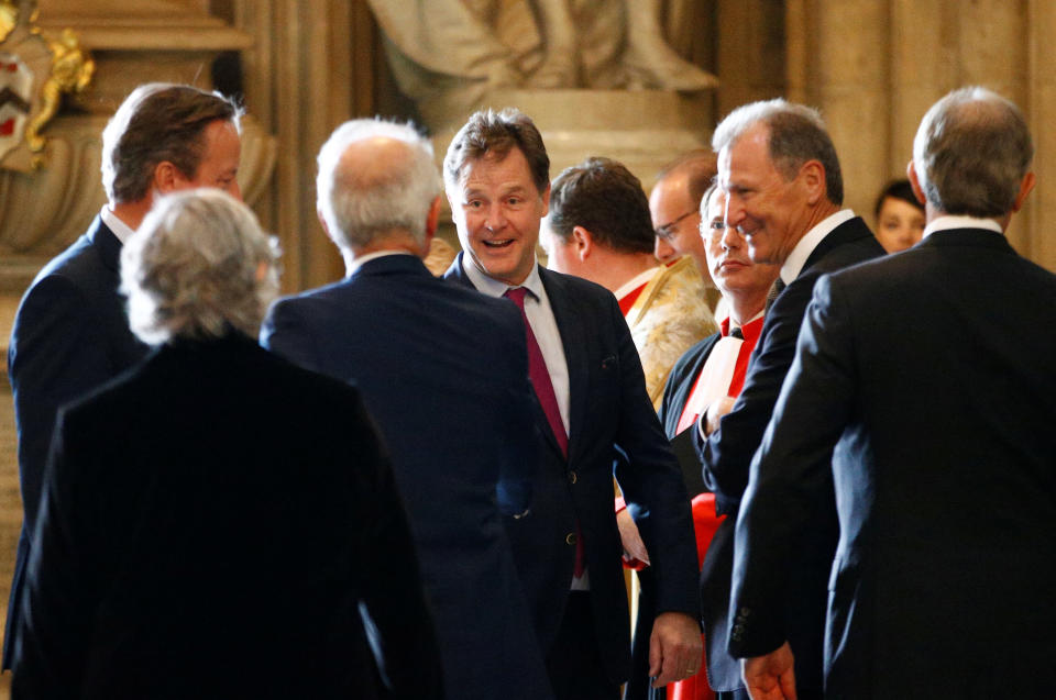 Britain's Former Deputy Prime Minister Nick Clegg, surrounded by guests at a party, greets an acquaintance. 