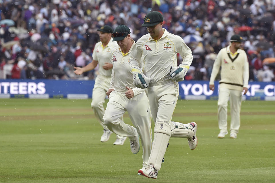 Australia's Alex Carey sprints off the field to avid the rains the match is delayed during day three of the first Ashes Test cricket match between England and Australia at Edgbaston, Birmingham, England, Sunday, June 18, 2023. (AP Photo/Rui Vieira)