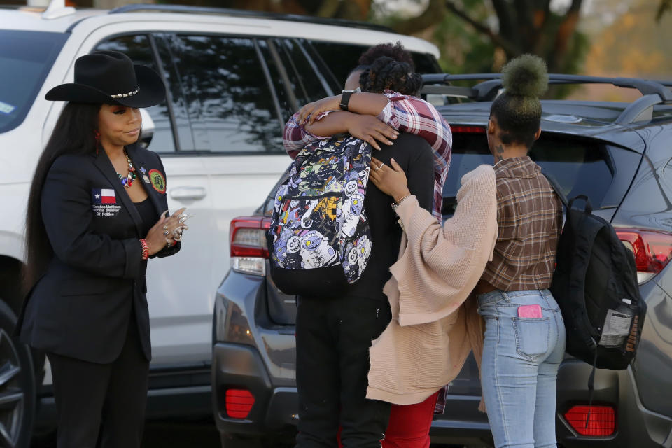 Darryl George, center left, a 17-year-old junior, and his mother Darresha George, center right, share a hug before walking across the street to go into Barbers Hill High School after Darryl served a 5-day in-school suspension for not cutting his hair Monday, Sept. 18, 2023, in Mont Belvieu. (AP Photo/Michael Wyke)
