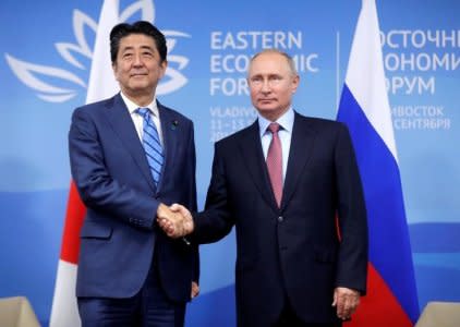 FILE PHOTO: Russian President Vladimir Putin shakes hands with Japanese Prime Minister Shinzo Abe during their meeting on the sidelines of the Eastern Economic Forum in Vladivostok, Russia September 10, 2018. Mikhail Metzel/TASS Host Photo Agency/Pool via REUTERS