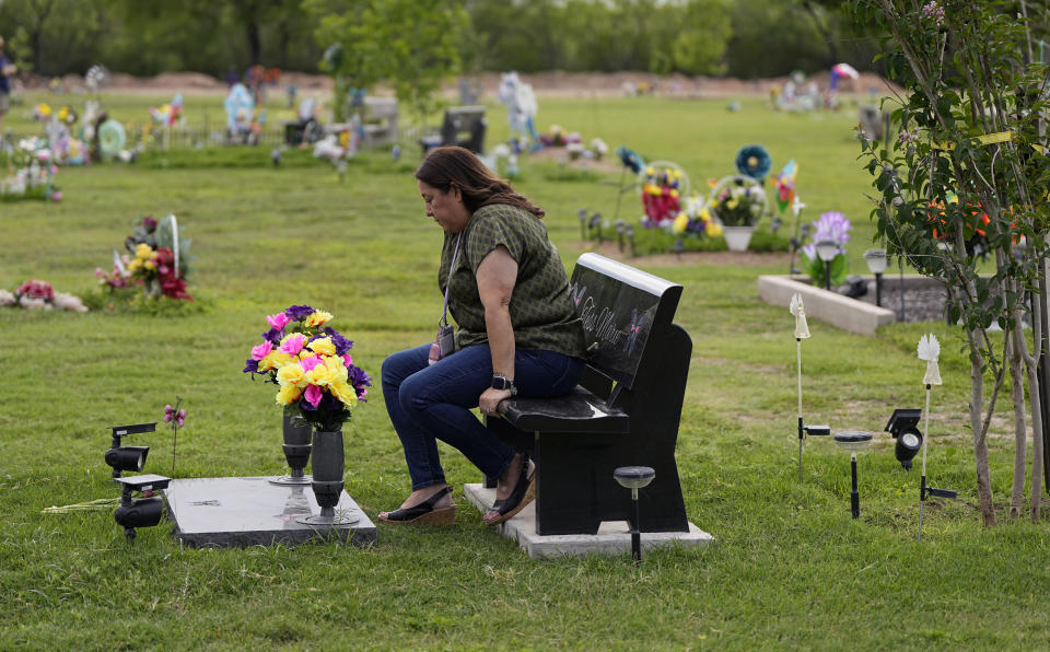 Veronica Mata visits the gravesite of her daugher, Tess, in Uvalde, Texas, Wednesday, May 3, 2023. For Mata, teaching kindergarten in Uvalde after her daughter was among the 19 students who were fatally shot at Robb Elementary School became a year of grieving for her own child while trying to keep 20 others safe. (AP Photo/Eric Gay)