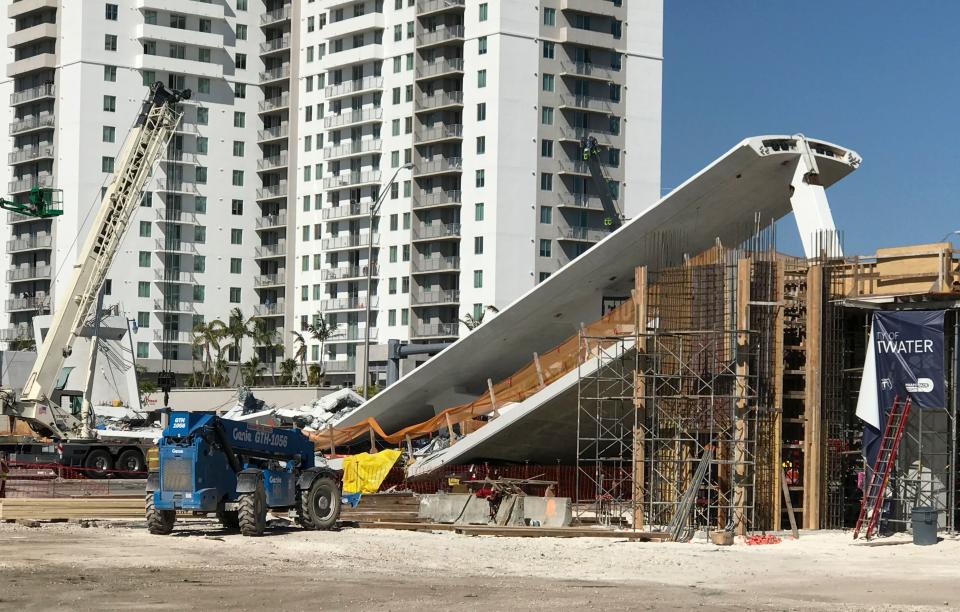 A crane is seen near&nbsp;the collapsed pedestrian bridge.&nbsp;