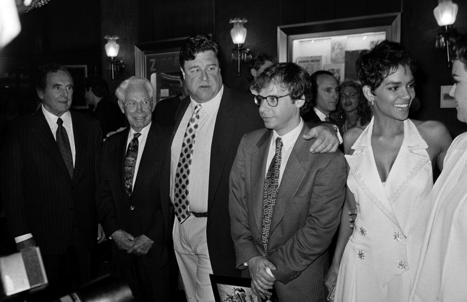 (L-R) Joseph Barbera, William Hanna, John Goodman, Rick Moranis, Halle Berry, and Rosie O'Donnell attend an event at the Ziegfeld Theatre in New York City on May 23, 1994. (Photo by Eric Weiss/WWD/Penske Media via Getty Images)