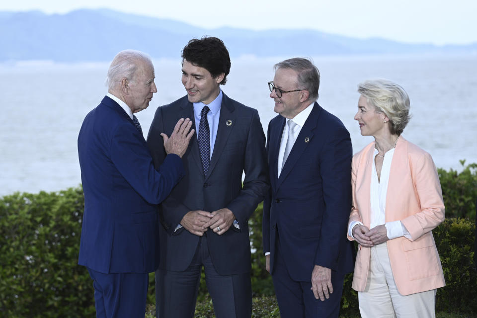 U.S. President Joe Biden, left, speaks with Canada's Prime Minister Justin Trudeau, center, Australia's Prime Minister Anthony Albanese, second right, and European Commission President Ursula von der Leyen during a a family photo session of leaders of the G7 and invited countries during the G7 Leaders' Summit in Hiroshima, western Japan, Saturday, May 20, 2023. (Brendan Smialowski/Pool Photo via AP)