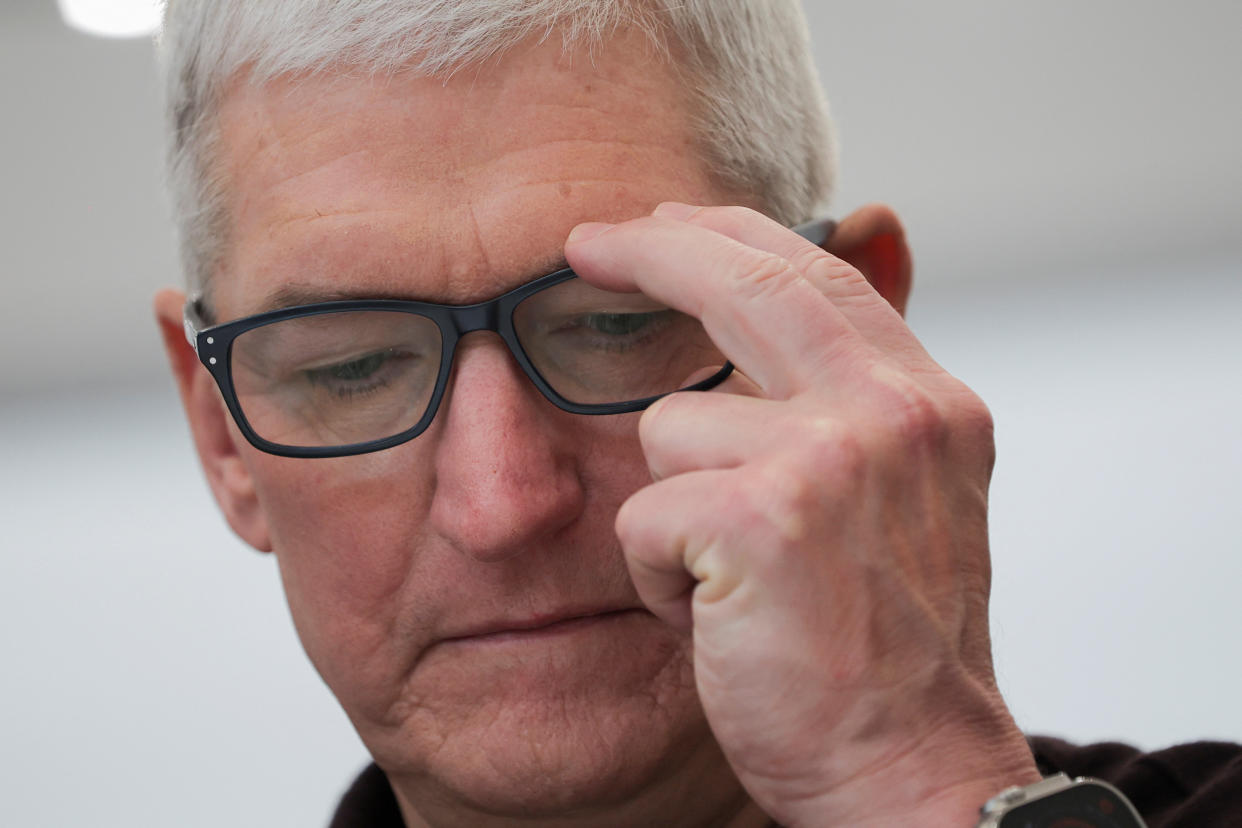 Apple CEO Tim Cook touches his glasses during an Apple event at their headquarters.