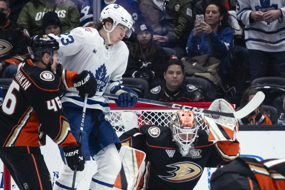 Anaheim Ducks goaltender Lukas Dostal (1) blocks a shot in front of Toronto Maple Leafs left wing Matthew Knies (23) during the first period of an NHL hockey game Wednesday, Jan. 3, 2024, in Anaheim, Calif. (AP Photo/Kyusung Gong)