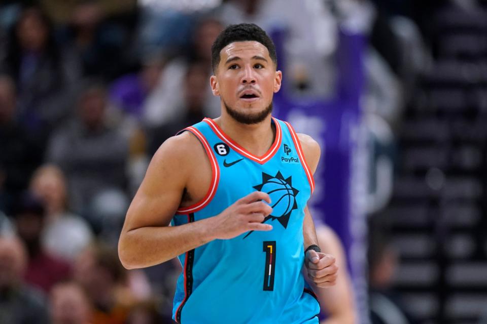 Phoenix Suns guard Devin Booker (1) runs upcourt after scoring against the Utah Jazz during the first half of an NBA basketball game Friday, Nov. 18, 2022, in Salt Lake City. (AP Photo/Rick Bowmer)