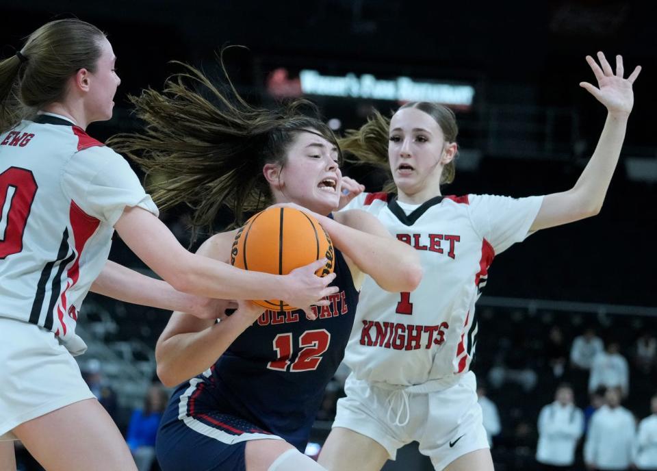 Toll Gate guard Adeline Areson tries to push a pass to a teammate in the second half while double teamed by Scarlet Knights Ella Johnson and Kate Hebert.