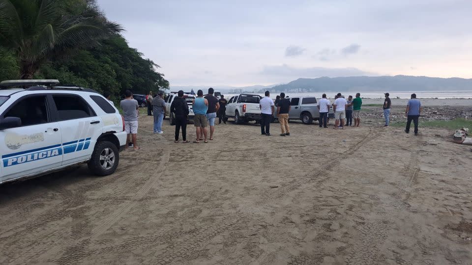 Ecuadorian police and people gather at the scene where Ecuador's youngest mayor, Brigitte Garcia was found shot dead in a car, according to the police, near San Vicente, Ecuador, in this handout image released on March 24, 2024. - National Police of Ecuador/Handout/Reuters