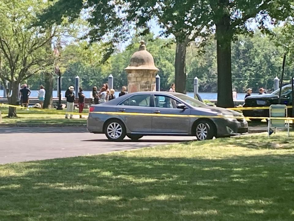 County detectives are examining a dark grey Toyota sedan parked near the shooting scene in Lions Park at the Bristol wharf on May 30, 2023.