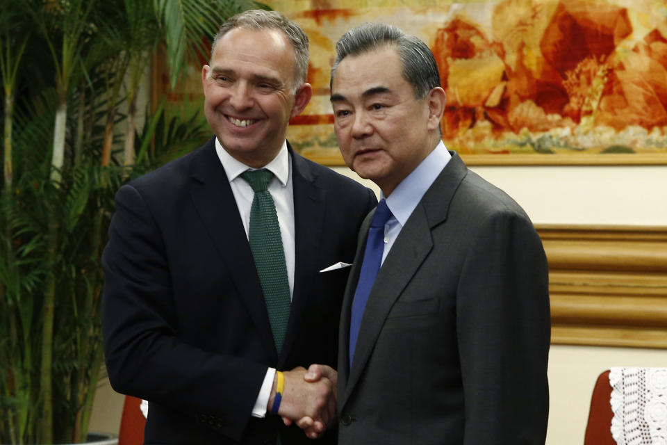 FILE - In this file photo dated Wednesday, May 8, 2019, Britain's National Security Adviser Mark Sedwill shakes hands with Chinese Foreign Minister Wang Yi, right, in Beijing. Britain’s top civil servant Mark Sedwill announced Sunday June 28, 2020, he will resign from his role as Cabinet Secretary, national security adviser and head of the Civil Service in September 2020. (Florence Lo/Pool FILE via AP)
