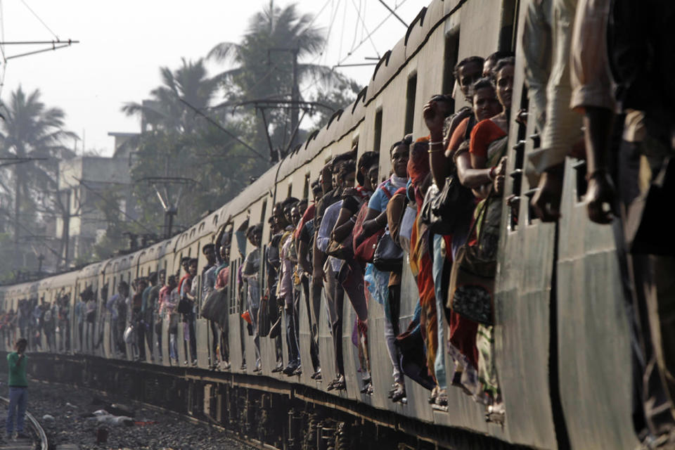 Indian commuters travel in a local train in Kolkata, India.