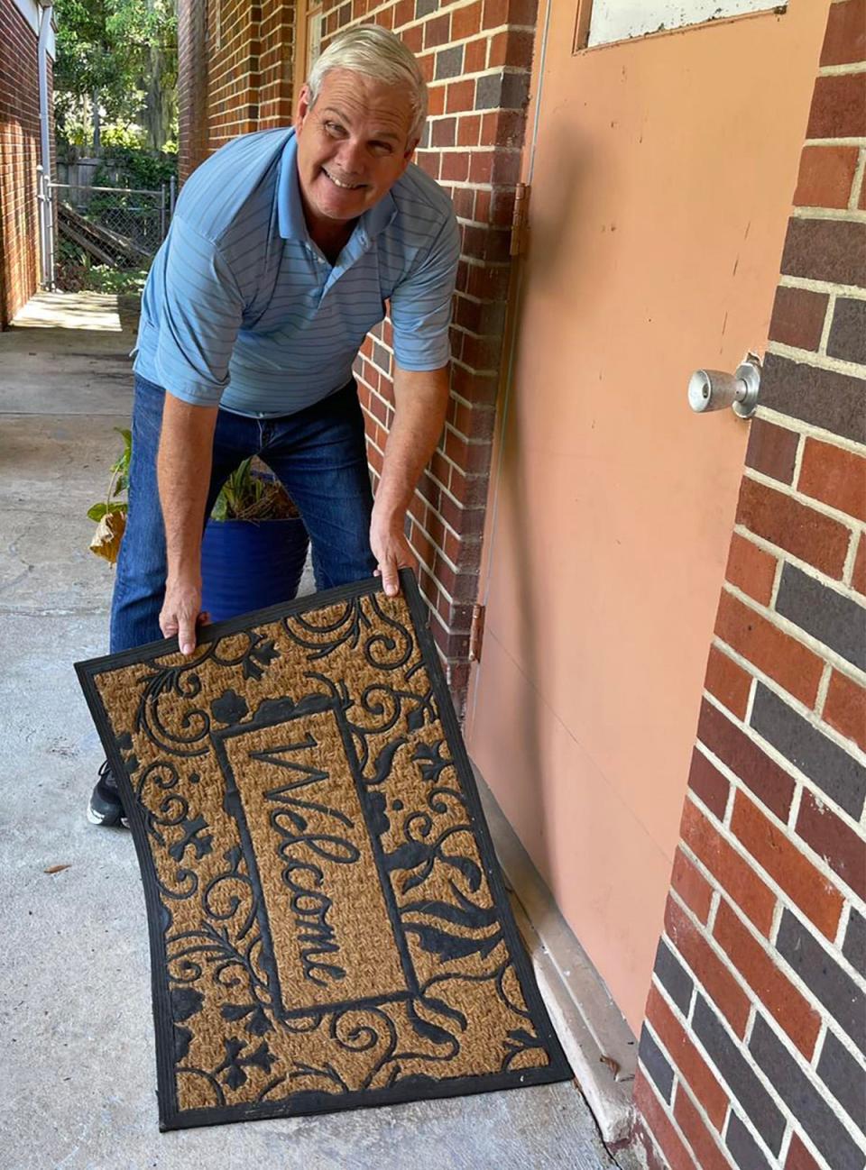 Executive Director Mark Landschoot (right) puts out the welcome mat at the new offices of Family Promise of Jacksonville, which helps homeless families and families at risk of becoming homeless.