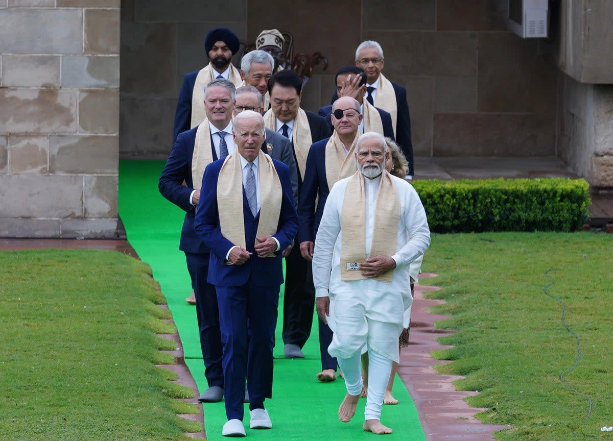 Indian prime minister Narendra Modi (front right) walks with US president Joe Biden and others at the Gandhi memorial yesterday (EPA)